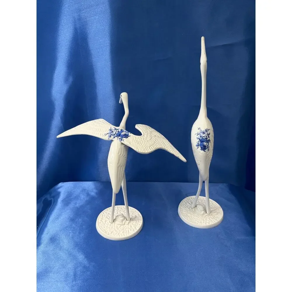 Pair of White Enamel Metal Cranes Accented with Blue Flower Design